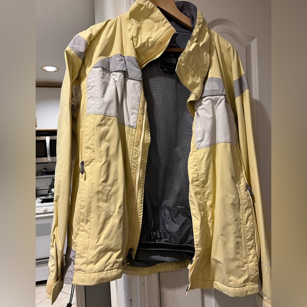 Used North Face ski jacket. 2 pieces. Size L. Light yellow colored.